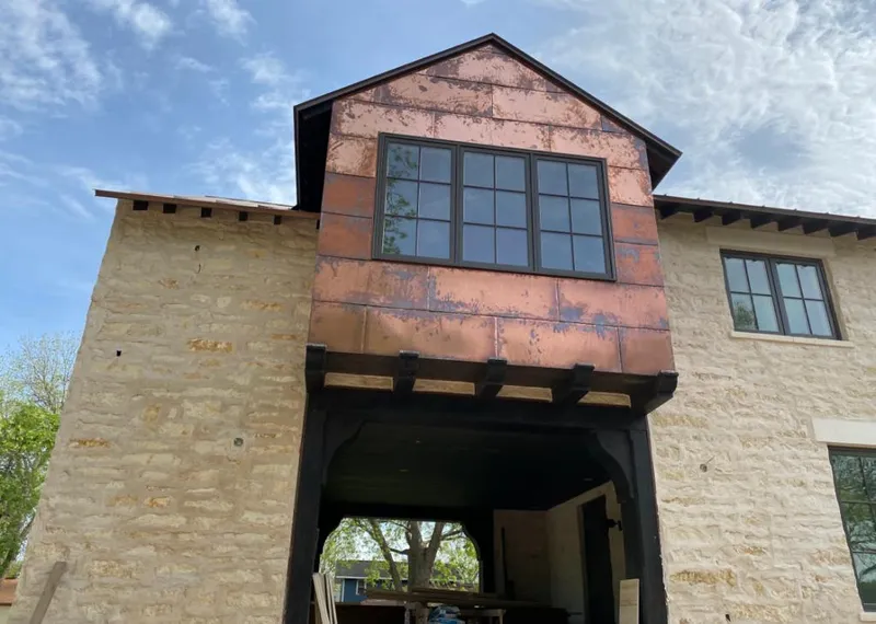 Copper metal panel facade on a stone building for Metal Roof Coating in Hutchison
